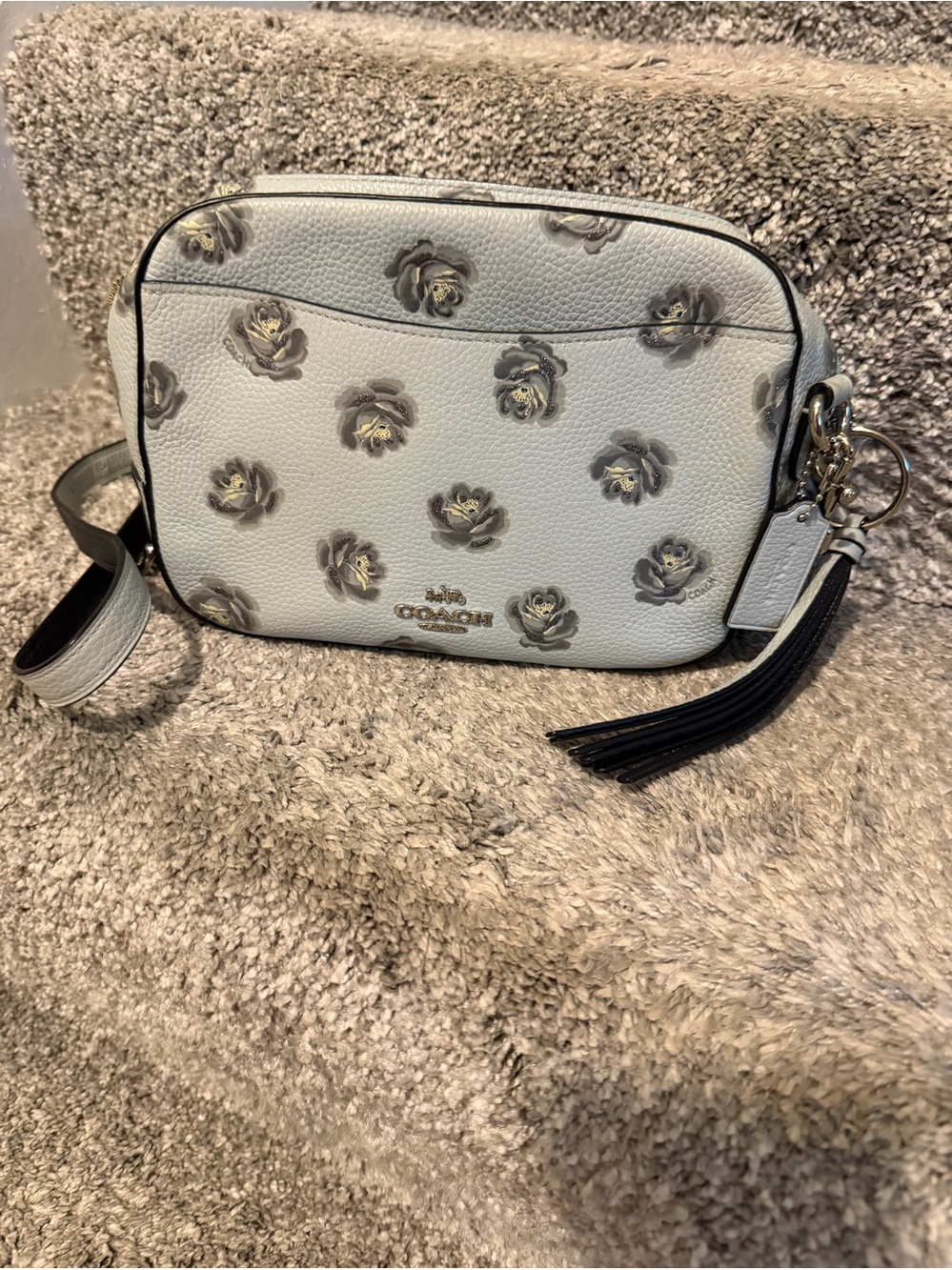 Coach Camera Bag with Rose Print, crafted from polished pebble leather.